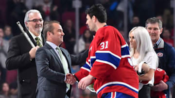 MONTREAL, QC - MARCH 16: President and chief executive officer of the Montreal Canadiens Geoff Molson shakes hands with goaltender Carey Price #31 while Michel Plante, son of hockey Hall of Famer Jacques Plante (L), wife Angela Price and father Jerry Price (R) look on during the pre-game ceremony prior to the NHL game between the Montreal Canadiens and the Chicago Blackhawks at the Bell Centre on March 16, 2019 in Montreal, Quebec, Canada. The Chicago Blackhawks defeated the Montreal Canadiens 2-0. (Photo by Minas Panagiotakis/Getty Images)