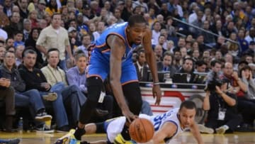November 14, 2013; Oakland, CA, USA; Oklahoma City Thunder small forward Kevin Durant (35, top) fights for a loose ball with Golden State Warriors point guard Stephen Curry (30, bottom) during the second quarter at Oracle Arena. Mandatory Credit: Kyle Terada-USA TODAY Sports
