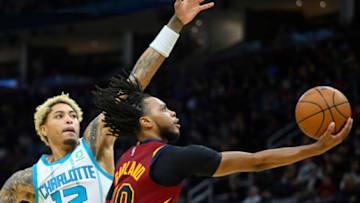 Mar 2, 2022; Cleveland, Ohio, USA; Cleveland Cavaliers guard Darius Garland (10) moves to the basket beside Charlotte Hornets guard Kelly Oubre Jr. (12) in the third quarter at Rocket Mortgage FieldHouse. Mandatory Credit: David Richard-USA TODAY Sports