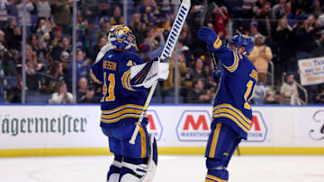 Mar 10, 2022; Buffalo, New York, USA; Buffalo Sabres goaltender Craig Anderson (41) and defenseman Henri Jokiharju (10) celebrate a win over the Vegas Golden Knights at KeyBank Center. Mandatory Credit: Timothy T. Ludwig-USA TODAY Sports