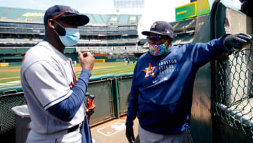OAKLAND, CA - April 4: Yordan Alvarez #44 and Dusty Baker Jr. #12 of the Houston Astros talk in the dugout before the game against the Oakland Athletics at RingCentral Coliseum on April 4, 2021 in Oakland, California. The Astros defeated the Athletics 9-2. (Photo by Michael Zagaris/Oakland Athletics/Getty Images)