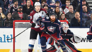 COLUMBUS, OH - MARCH 8: Nathan McKinnon #29 of the Colorado Avalanche and Ian Cole #23 of the Columbus Blue Jackets battle for position in front of goaltender Joonas Korpisalo #70 of the Columbus Blue Jackets on March 8, 2018 at Nationwide Arena in Columbus, Ohio. (Photo by Jamie Sabau/NHLI via Getty Images)