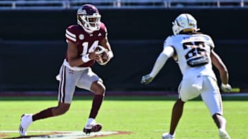 Oct 7, 2023; Starkville, Mississippi, USA; Mississippi State Bulldogs quarterback Mike Wright (14) runs the ball while defended by Western Michigan Broncos cornerback Aaron Wofford (25) during the fourth quarter at Davis Wade Stadium at Scott Field. Mandatory Credit: Matt Bush-USA TODAY Sports