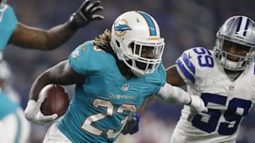 Aug 19, 2016; Arlington, TX, USA; Miami Dolphins running back Jay Ajayi (23) runs the ball against Dallas Cowboys middle linebacker Anthony Hitchens (59) in the second quarter at AT&T Stadium. Mandatory Credit: Tim Heitman-USA TODAY Sports