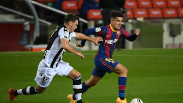 Levante's Montenegrin midfielder Nikola Vukcevic (L) challenges Barcelona's Brazilian midfielder Philippe Coutinho during the Spanish league football match between FC Barcelona and Levante UD at the Camp Nou stadium in Barcelona on December 13, 2020. (Photo by LLUIS GENE / AFP) (Photo by LLUIS GENE/AFP via Getty Images)