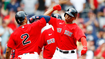 BOSTON, MASSACHUSETTS - JULY 01: Rafael Devers #11 of the Boston Red Sox celebrates with Xander Bogaerts #2 of the Boston Red Sox after hitting a 2 RBI home run in the bottom of the sixth inning of the game against the Kansas City Royals at Fenway Park on July 01, 2021 in Boston, Massachusetts. (Photo by Omar Rawlings/Getty Images)