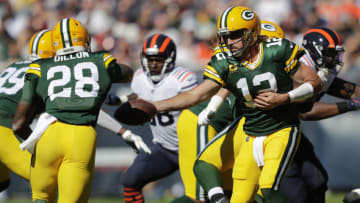 Oct 17, 2021; Chicago, IL, USA; Green Bay Packers quarterback Aaron Rodgers (12) hands off to running back AJ Dillon (28) in the second quarter against the Chicago Bears during their football game Sunday, October 17, 2021, at Soldier Field in Chicago, Ill. Green Bay won 24-14. Mandatory Credit: Dan Powers-USA TODAY Sports