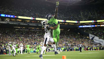 SEATTLE, WASHINGTON - OCTOBER 03: D.K. Metcalf #14 of the Seattle Seahawks reaches for an incomplete pass against Marcus Peters #22 of the Los Angeles Rams in the fourth quarter during their game at CenturyLink Field on October 03, 2019 in Seattle, Washington. (Photo by Abbie Parr/Getty Images)
