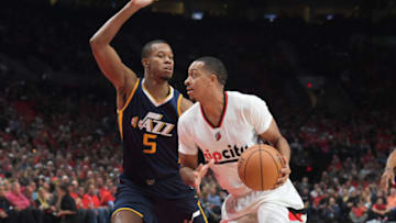 PORTLAND, OR - SEPTEMBER 25: C.J. McCollum #3 of the Portland Trail Blazers drives to the basket on Rodney Hood #5 of the Utah Jazz in the first quarter of an NBA game at the Moda Center on September 25, 2016 in Portland, Oregon. (Photo by Steve Dykes/Getty Images)
