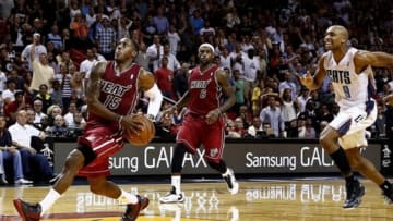Dec 1, 2013; Miami, FL, USA; Miami Heat point guard Mario Chalmers (15) drives to the basket as small forward LeBron James (6) and Charlotte Bobcats shooting guard Gerald Henderson (9) look on in the second half at American Airlines Arena. The Heat won 99-98. Mandatory Credit: Robert Mayer-USA TODAY Sports