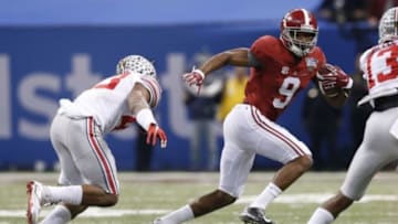 Jan 1, 2015; New Orleans, LA, USA; Alabama Crimson Tide wide receiver Amari Cooper (9) runs the ball past Ohio State Buckeyes defense during the second quarter in the 2015 Sugar Bowl at Mercedes-Benz Superdome. Mandatory Credit: Matthew Emmons-USA TODAY Sports