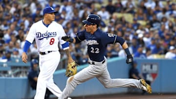 LOS ANGELES, CA - JULY 31: Christian Yelich #22 of the Milwaukee Brewers rounds the bases on his way to scoring a run on a double off the bat of Lorenzo Cain of the Milwaukee Brewers as Manny Machado #8 of the Los Angeles Dodgers looks on in the third inning against the Los Angeles Dodgers at Dodger Stadium on July 31, 2018 in Los Angeles, California. (Photo by Jayne Kamin-Oncea/Getty Images)