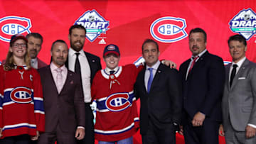 VANCOUVER, BRITISH COLUMBIA - JUNE 21: Cole Caufield (fifth from left), fifteenth overall pick of the Montreal Canadiens, poses for a group photo with team personnel onstage during the first round of the 2019 NHL Draft at Rogers Arena on June 21, 2019 in Vancouver, Canada. (Photo by Dave Sandford/NHLI via Getty Images)