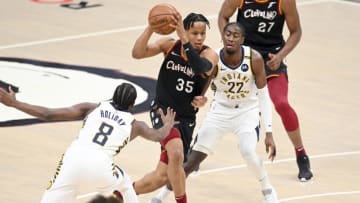 CLEVELAND, OHIO - MAY 10: Isaac Okoro #35 of the Cleveland Cavaliers drives to the basket between Justin Holiday #8 and Caris LeVert #22 of the Indiana Pacers during the first quarter at Rocket Mortgage Fieldhouse on May 10, 2021 in Cleveland, Ohio. NOTE TO USER: User expressly acknowledges and agrees that, by downloading and/or using this photograph, user is consenting to the terms and conditions of the Getty Images License Agreement. (Photo by Jason Miller/Getty Images)