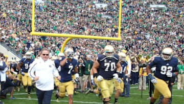 Sep 21, 2013; South Bend, IN, USA; Notre Dame Fighting Irish coach Brian Kelly leads his team onto the field before the game against the Michigan State Spartans at Notre Dame Stadium. Mandatory Credit: Brian Spurlock-USA TODAY Sports