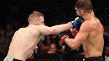MELBOURNE, AUSTRALIA - OCTOBER 06: (L-R) Dan Hooker of New Zealand punches Al Iaquinta in their lightweight fight during the UFC 243 event at Marvel Stadium on October 06, 2019 in Melbourne, Australia. (Photo by Jeff Bottari/Zuffa LLC/Zuffa LLC via Getty Images)