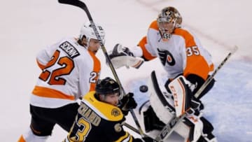 Oct 8, 2014; Boston, MA, USA; Boston Bruins left wing Brad Marchand (63) and Philadelphia Flyers goalie Steve Mason (35) focus on the puck during the first period at TD Banknorth Garden. Mandatory Credit: Greg M. Cooper-USA TODAY Sports