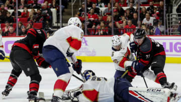 RALEIGH, NC - NOVEMBER 23: Carolina Hurricanes Left Wing Brock McGinn (23) battles with Florida Panthers Defenceman Anton Stralman (6) for a puck that was stopped by Florida Panthers Goalie Sergei Bobrovsky (72) during an NHL game between the Florida Panthers and the Carolina Hurricanes on November 23, 2019 at the PNC Arena in Raleigh, NC. (Photo by John McCreary/Icon Sportswire via Getty Images)