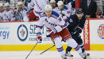 Dec 8, 2016; Winnipeg, Manitoba, CAN; New York Rangers defenseman Brady Skjei (76) controls the puck past Winnipeg Jets center Bryan Little (18) during the third period at MTS Centre. Rangers win 2-1. Mandatory Credit: Bruce Fedyck-USA TODAY Sports