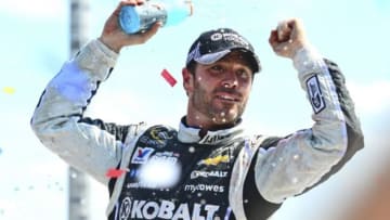 Jun 15, 2014; Brooklyn, MI, USA; NASCAR Sprint Cup Series driver Jimmie Johnson celebrates in victory lane after winning the Quicken Loans 400 at Michigan International Speedway. Mandatory Credit: Andrew Weber-USA TODAY Sports