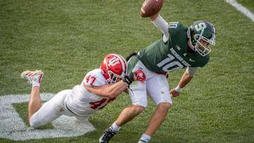 EAST LANSING, MI - NOVEMBER 14: Micah McFadden #47 of the Indiana Hoosiers tackles Payton Thorne #10 of the Michigan State Spartans during the fourth quarter at Spartan Stadium on November 14, 2020 in East Lansing, Michigan. (Photo by Nic Antaya/Getty Images)