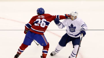 TORONTO, ONTARIO - JULY 28: Jeff Petry #26 of the Montreal Canadiens and Zach Hyman #11 of the Toronto Maple Leafs fight for position in the second period during an exhibition game prior to the 2020 NHL Stanley Cup Playoffs at Scotiabank Arena on July 28, 2020 in Toronto, Ontario. (Photo by Andre Ringuette/Freestyle Photo/Getty Images)