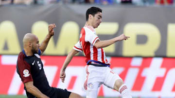 PHILADELPHIA, PA - JUNE 11: Miguel Almiron #17 of Paraguay tries to keep the ball as John Brooks #6 of United States slides in the first half during the Copa America Centenario Group C match at Lincoln Financial Field on June 11, 2016 in Philadelphia, Pennsylvania. (Photo by Elsa/Getty Images)