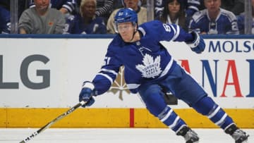 Jake Gardiner #51 of the Toronto Maple Leafs reaches for a puck. (Photo by Claus Andersen/Getty Images)