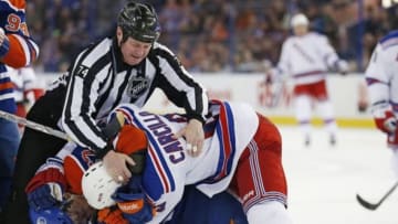 Mar 30, 2014; Edmonton, Alberta, CAN; Edmonton Oilers forward David Perron (57) and New York Rangers forward Dan Carcillo (13) fight during the third period at Rexall Place. Mandatory Credit: Perry Nelson-USA TODAY Sports