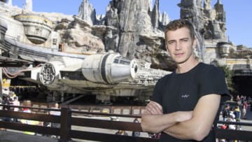 Actor Hayden Christensen poses in front of the Millennium Falcon: Smugglers Run in Star Wars: Galaxy's Edge while vacationing at Disneyland Park
