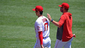 ANAHEIM, CA - AUGUST 02: Shohei Ohtani #17 walks with pitching coach Mickey Callaway #75 of the Los Angeles Angels to warm up in the bullpen before the game against the Houston Astros at Angel Stadium of Anaheim on August 2, 2020 in Anaheim, California. (Photo by Jayne Kamin-Oncea/Getty Images)