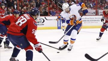 Feb 4, 2014; Washington, DC, USA; New York Islanders left wing Thomas Vanek (26) skates with the puck as Washington Capitals defenseman John Erskine (4) and Capitals defenseman Connor Carrick (58) defend in the first period at Verizon Center. Mandatory Credit: Geoff Burke-USA TODAY Sports