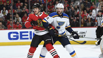 CHICAGO, IL - APRIL 06: David Kampf #64 of the Chicago Blackhawks and Joel Edmundson #6 of the St. Louis Blues watch for the puck in the first period at the United Center on April 6, 2018 in Chicago, Illinois. (Photo by Bill Smith/NHLI via Getty Images)