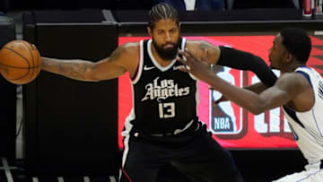 May 22, 2021; Los Angeles, California, USA; LA Clippers guard Paul George (13) passes the ball as Dallas Mavericks guard Josh Richardson (0) tries to defend during the third quarter of game one in the first round of the 2021 NBA Playoffs at Staples Center. Mandatory Credit: Robert Hanashiro-USA TODAY Sports