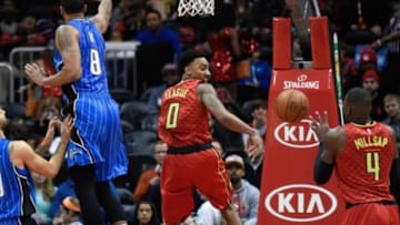 Jan 18, 2016; Atlanta, GA, USA; Atlanta Hawks guard Jeff Teague (0) passes the ball back to forward Paul Millsap (4) in front of Orlando Magic forward Channing Frye (8) during the first half at Philips Arena. Mandatory Credit: Dale Zanine-USA TODAY Sports
