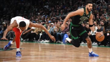 Mar 3, 2023; Boston, Massachusetts, USA; Boston Celtics forward Jayson Tatum (0) dribbles against Brooklyn Nets forward Mikal Bridges (1) during the first half at TD Garden. Mandatory Credit: Bob DeChiara-USA TODAY Sports