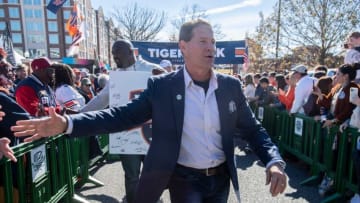Former Auburn football coach Gene Chizik greets fans during tiger walk before Auburn Tigers take on Alabama Crimson Tide at Jordan-Hare Stadium in Auburn, Ala., on Saturday, Nov. 27, 2021.