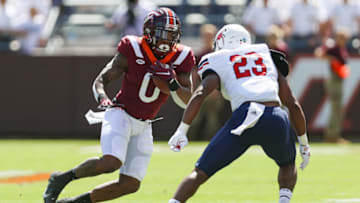 Sep 25, 2021; Blacksburg, Virginia, USA; Virginia Tech Hokies running back Jalen Holston (0) evades Richmond Spiders linebacker Xavier Marshall (23) during the second quarter at Lane Stadium. Mandatory Credit: Ryan Hunt-USA TODAY Sports