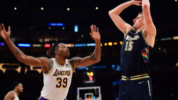 Apr 3, 2022; Los Angeles, California, USA; Denver Nuggets center Nikola Jokic (15) shoots against Los Angeles Lakers center Dwight Howard (39) during the first half at Crypto.com Arena. Mandatory Credit: Gary A. Vasquez-USA TODAY Sports
