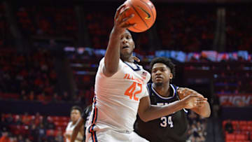 Nov 6, 2023; Champaign, Illinois, USA; Illinois Fighting Illini forward Dain Dainja (42) grabs a loose ball in front of Eastern Illinois Panthers forward Jermaine Hamlin (34) during the first half at State Farm Center. Mandatory Credit: Ron Johnson-USA TODAY Sports