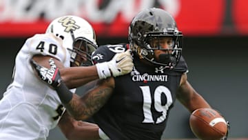 Cincinnati Bearcats wide receiver Shaq Washington is tackled by UCF Knights linebacker Chequan Burkett. USA Today.