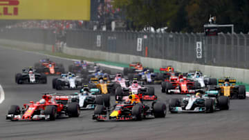 MEXICO CITY, MEXICO - OCTOBER 29: Max Verstappen of the Netherlands driving the (33) Red Bull Racing Red Bull-TAG Heuer RB13 TAG Heuer, Sebastian Vettel of Germany driving the (5) Scuderia Ferrari SF70H and Lewis Hamilton of Great Britain driving the (44) Mercedes AMG Petronas F1 Team Mercedes F1 WO8 battle for position into turn one at the start during the Formula One Grand Prix of Mexico at Autodromo Hermanos Rodriguez on October 29, 2017 in Mexico City, Mexico. (Photo by Clive Rose/Getty Images)