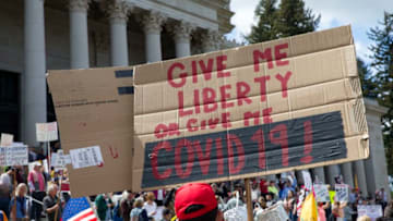OLYMPIA, WA - APRIL 19: Hundreds gather to protest the state's stay-at-home order, at the Capitol building on April 19, 2020 in Olympia, Washington. Washington state Gov. Jay Inslee instituted the order last month in an effort to slow the spread of the coronavirus (COVID-19). (Photo by Karen Ducey/Getty Images)