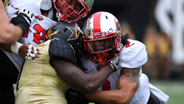 Nov 4, 2017; Nashville, TN, USA; Vanderbilt Commodores running back Ralph Webb (7) is stopped by WKU Hilltoppers defensive back Devon Key (2) during the first half at Vanderbilt Stadium. Mandatory Credit: Christopher Hanewinckel-USA TODAY Sports