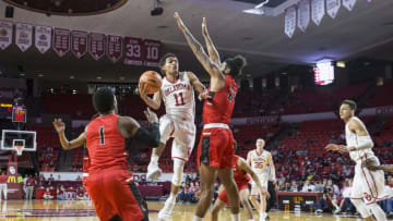 NORMAN, OK - NOVEMBER 15: Trae Young (11) of the Oklahoma Sooners drives to the basket against Trey Moses (24) of the Ball State Cardinals during the Oklahoma Sooners against the Ball State Cardinals at the Lloyd Noble Center in Norman, Ok. (Photo by Richard Rowe/Icon Sportswire via Getty Images)