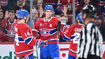 MONTREAL, CANADA - SEPTEMBER 27: Sean Monahan #91 of the Montreal Canadiens celebrates his goal with teammates Nick Suzuki #14 and Cole Caufield #22 during the third period against the Ottawa Senators at the Bell Centre on September 27, 2023 in Montreal, Quebec, Canada. The Montreal Canadiens defeated the Ottawa Senators 4-3. (Photo by Minas Panagiotakis/Getty Images)