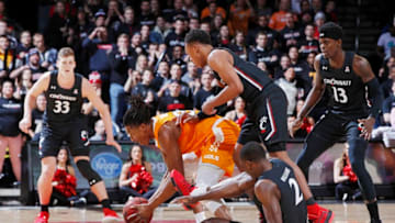 CINCINNATI, OH - DECEMBER 18: Yves Pons #35 of the Tennessee Volunteers tries to gather a loose ball against Keith Williams #2 and Mika Adams-Woods #3 of the Cincinnati Bearcats in the first half of the game at Fifth Third Arena on December 18, 2019 in Cincinnati, Ohio. (Photo by Joe Robbins/Getty Images)