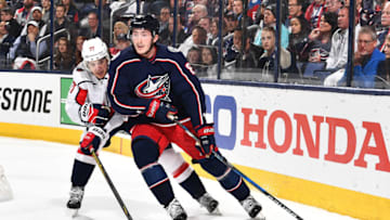 COLUMBUS, OH - APRIL 23: Zach Werenski #8 of the Columbus Blue Jackets shields the puck from T.J. Oshie #77 of the Washington Capitals during the first period in Game Six of the Eastern Conference First Round during the 2018 NHL Stanley Cup Playoffs on April 23, 2018 at Nationwide Arena in Columbus, Ohio. (Photo by Jamie Sabau/NHLI via Getty Images)