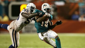 MIAMI - SEPTEMBER 21: Linebacker Clint Session #55 of the Indianapolis Colts brings down wide receiver Ted Ginn Jr. #19 of the Miami Dolphins at Land Shark Stadium on September 21, 2009 in Miami, Florida. The Colts defeated the Dolphins 27-23. (Photo by Doug Benc/Getty Images)