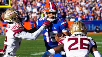 Florida State Seminoles defensive back Jarques McClellion (15) tries to tackle Florida Gators quarterback Anthony Richardson (15) in the second half. The Florida Gators defeated the Florida State Seminoles 24-21 Saturday November 27, 2021 at Ben Hill Griffin Stadium in Gainesville, Florida. [Doug Engle/Ocala Star-Banner]2021Flgai 112721 Ufvsfsu Fb